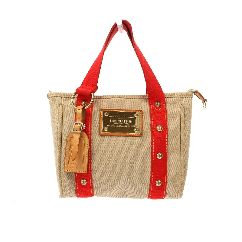 Louis Vuitton tote bags with a spacious interior and multiple pocketsLOUIS VUITTON Handbag in Beige Fabric